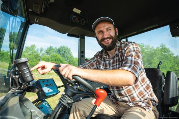 Smiling farmer sitting in his tractor