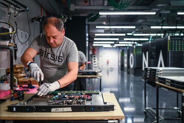 An IT specialist working on electronic equipment